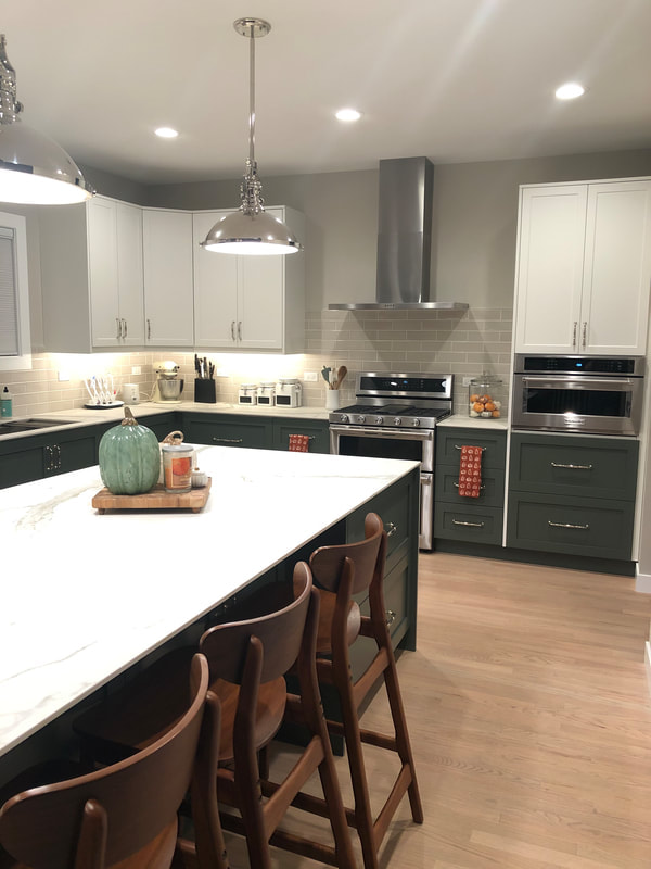 Our client who is located in River North in chicago wanted green and white cabinets with a big waterfall countertop for her kitchen remodel, here is the result 